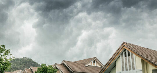 Cloudy sky over roof depicts rain which is a main problem during roofing projects