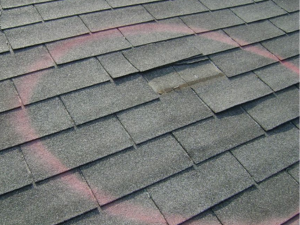 Storm-damaged roof in Sheboygan County inspected by Gellings Roofing & Siding.