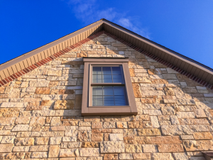 Installation of stone veneer siding by Gellings Roofing in Sheboygan County.